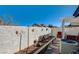 Private patio area with a decorative wall, garden bed, and comfortable outdoor seating, ideal for outdoor living at 420 Blush Creek Pl, Las Vegas, NV 89144