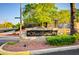 Community entrance sign for Sunset Mesa, set amongst manicured landscaping and mature trees at 420 Blush Creek Pl, Las Vegas, NV 89144