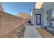 Backyard patio with seating area, concrete path, and desert landscaping, ideal for outdoor enjoyment at 4833 Integrity St, North Las Vegas, NV 89031