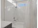 Bright bathroom with a shower-tub combo featuring white marble tile at 4833 Integrity St, North Las Vegas, NV 89031