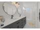 Bathroom featuring double sinks with modern black fixtures, tiled floors, and a shower/tub combo at 4833 Integrity St, North Las Vegas, NV 89031