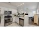 Modern kitchen with stainless steel appliances, white cabinets, and tile flooring at 4833 Integrity St, North Las Vegas, NV 89031