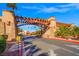 Beautiful community entrance featuring stone supports, pergola covering, and lush palm trees at 5060 Indian River Dr # 382, Las Vegas, NV 89103