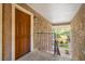 Inviting entryway featuring a solid wood door, textured walls, and a glimpse of lush greenery at 5060 Indian River Dr # 382, Las Vegas, NV 89103