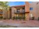 Condo building featuring dual balconies, stone accents, and desert landscaping at 5060 Indian River Dr # 382, Las Vegas, NV 89103