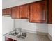 Close-up of the kitchen, with wood cabinets, stainless steel sink, and countertops for efficient meal preparation at 5060 Indian River Dr # 382, Las Vegas, NV 89103