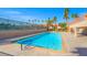 Beautiful rectangular community pool surrounded by palm trees and a clear blue sky at 5060 Indian River Dr # 382, Las Vegas, NV 89103