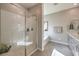 Bright bathroom with a glass shower, a soaking tub and double sink vanity at 510 Copper Falcon Ave, Henderson, NV 89011