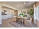 The dining area features modern lighting, a natural-tone rug, and windows for ample sunlight at 510 Copper Falcon Ave, Henderson, NV 89011