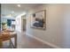 Inviting home entryway with neutral tile floors, modern artwork, and views to the dining area at 510 Copper Falcon Ave, Henderson, NV 89011