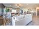 Open-concept living room featuring neutral decor, ceiling fan, and seamless flow into the kitchen and dining areas at 510 Copper Falcon Ave, Henderson, NV 89011