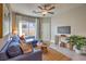 Comfortable living room with a blue sectional, ceiling fan, and a view to the outside at 510 Copper Falcon Ave, Henderson, NV 89011