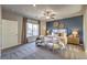 Bedroom featuring a large window, ceiling fan, and decorative wall art above the headboard at 510 Copper Falcon Ave, Henderson, NV 89011