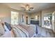 Comfortable bedroom featuring neutral walls, ceiling fan, and access to the bathroom and balcony at 510 Copper Falcon Ave, Henderson, NV 89011