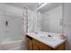 Bathroom featuring a tub and shower combination, double sinks and a large mirror at 5541 Ramirez St, North Las Vegas, NV 89031