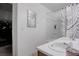 Bright bathroom featuring double sinks, shower over bath with curtain and adjacent closet with clothes at 5541 Ramirez St, North Las Vegas, NV 89031