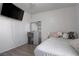 Bedroom with wood floors, a bed, a vanity and a wall-mounted television at 5541 Ramirez St, North Las Vegas, NV 89031