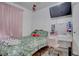 Bedroom featuring wood floors, a bed, a vanity and a wall-mounted television at 5541 Ramirez St, North Las Vegas, NV 89031