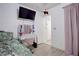 Bedroom featuring wood floors, a bed, a vanity and a wall-mounted television at 5541 Ramirez St, North Las Vegas, NV 89031