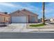 Single-story home with desert landscaping, two-car garage and paved driveway at 5541 Ramirez St, North Las Vegas, NV 89031