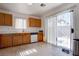 Bright kitchen features wood cabinets, tile flooring, and a sliding glass door for natural light and access to the backyard at 5541 Ramirez St, North Las Vegas, NV 89031