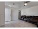 Inviting living room featuring neutral tile flooring and a comfortable leather sofa at 5541 Ramirez St, North Las Vegas, NV 89031