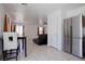 Stainless steel refrigerator overlooking living room with tile floors, and large windows at 5541 Ramirez St, North Las Vegas, NV 89031