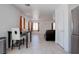 Tile floors throughout the living room, dining area and stainless steel refrigerator at 5541 Ramirez St, North Las Vegas, NV 89031