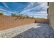 Backyard featuring gray pavers and gravel along the perimeter, enclosed by a brick wall at 5606 Spring Trellis St, Las Vegas, NV 89113