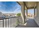 Balcony view showcasing the neighborhood street and a clear blue sky above the homes at 5606 Spring Trellis St, Las Vegas, NV 89113