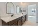 Elegant bathroom with double sink vanity, modern mirrors, and a sleek design at 5606 Spring Trellis St, Las Vegas, NV 89113