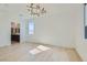 A light-filled bedroom with hardwood floors and a designer light fixture at 5606 Spring Trellis St, Las Vegas, NV 89113