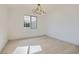 Bright bedroom with hardwood floors, stylish modern light fixture and a large window at 5606 Spring Trellis St, Las Vegas, NV 89113