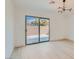 Sunlit bedroom with sliding glass doors leading to a private patio at 5606 Spring Trellis St, Las Vegas, NV 89113