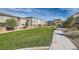 Scenic community park with lush green grass, walking path, and inviting gazebo seating area for residents to enjoy outdoors at 5606 Spring Trellis St, Las Vegas, NV 89113