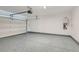 Spacious two car garage with epoxy flooring featuring a tankless water heater at 5606 Spring Trellis St, Las Vegas, NV 89113