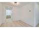 Bright hallway with light wood floors and white walls, illuminated by a modern ceiling light fixture at 5606 Spring Trellis St, Las Vegas, NV 89113