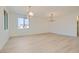 Minimalist living room with hardwood floors, contemporary lighting, and plenty of natural light at 5606 Spring Trellis St, Las Vegas, NV 89113