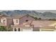 View of neighborhood homes with tiled roofs, set against a backdrop of scenic mountains at 5606 Spring Trellis St, Las Vegas, NV 89113