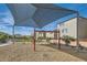 Neighborhood playground with a swing set and sunshade, complete with benches for relaxation at 5606 Spring Trellis St, Las Vegas, NV 89113