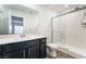 Bathroom featuring a single sink vanity, toilet, and a shower with glass doors at 5745 Becklow Gardens Ave, Las Vegas, NV 89141