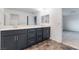 Well-lit bathroom featuring a double vanity with sleek countertops at 5745 Becklow Gardens Ave, Las Vegas, NV 89141