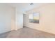 Cozy bedroom with neutral carpet, a window, and a closet with sliding doors at 5745 Becklow Gardens Ave, Las Vegas, NV 89141