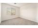 Cozy bedroom featuring a large window with blinds and neutral carpet at 5745 Becklow Gardens Ave, Las Vegas, NV 89141