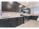 Contemporary kitchen with stainless steel appliances, sleek cabinetry, tile backsplash and ample counter space at 5745 Becklow Gardens Ave, Las Vegas, NV 89141