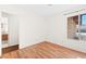 Bedroom featuring wood-look floors and view into the bathroom at 6130 Desert Sun Dr, Las Vegas, NV 89110