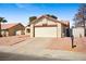 Inviting single-Gathering home featuring a two-car garage, low-maintenance desert landscaping, and a tile roof at 6130 Desert Sun Dr, Las Vegas, NV 89110