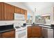 A corner of the kitchen with stainless steel appliances, wood cabinets, and natural light at 6130 Desert Sun Dr, Las Vegas, NV 89110