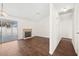 Living room with a brick fireplace, hardwood floors, and sliding glass doors to the pool at 6130 Desert Sun Dr, Las Vegas, NV 89110