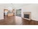 Open concept living area with a brick fireplace and seamless flow into a modern kitchen at 6130 Desert Sun Dr, Las Vegas, NV 89110